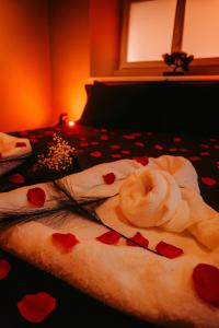 a pile of towels on a bed with hearts at Aphrodite House in Guebwiller