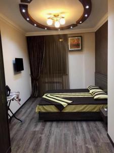 a bedroom with a bed and a ceiling at Elegant 3 bedroom apartment in center, next to Reppublic Square in Yerevan