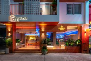 een gebouw met een restaurant in een stad 's nachts bij COMMON INN Thu Dau Mot in Ga Phú Văn