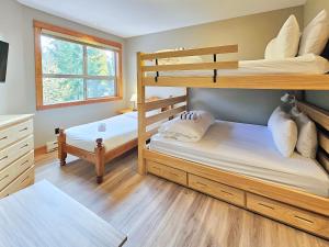 a bedroom with two bunk beds and a window at Timberline Lodges by Fernie Lodging Co in Fernie +82 photos