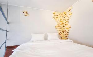 a bedroom with a white bed and a wall of books at Kyiv Muse Apartment in Kyiv