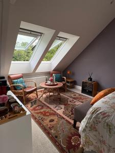 a attic room with a bed and a table at Manoir Saint-André,B&B de charme in Theix