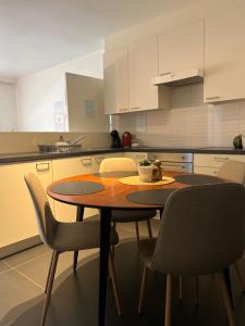 a kitchen with a wooden table and chairs at Elma’s Place in Ghent