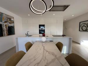 een eetkamer met een tafel en een keuken bij Luxury 2 bed apartment in Las Colinas in Orihuela-Costa