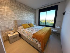 een slaapkamer met een bed en een bakstenen muur bij Luxury 2 bed apartment in Las Colinas in Orihuela-Costa +12 foto's
