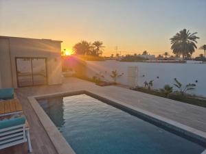 a swimming pool in the backyard of a house at Villa Midoun in Midoun