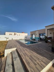 a large deck with a swimming pool on top of a house at Villa Midoun in Midoun