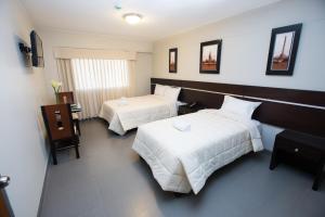 Cama ou camas em um quarto em Mariategui Hotel & Suites