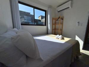 a bedroom with a bed with two towels on it at MHV Milagres - Studio Guadalupe 11 in Passo de Camarajibe +26 photos