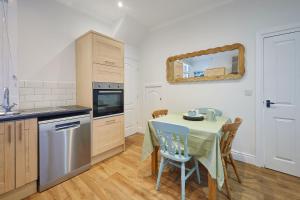 a kitchen with a table and a table and a mirror at Host & Stay - Prospect Retreat in Knaresborough +15 photos