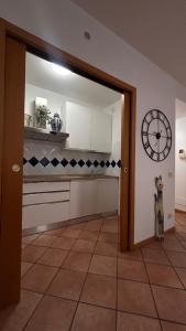 a kitchen with a dog standing in a room at Alida in Salò
