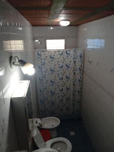 a bathroom with a toilet and a sink and a shower at Albricias in Mina Clavero +2 photos