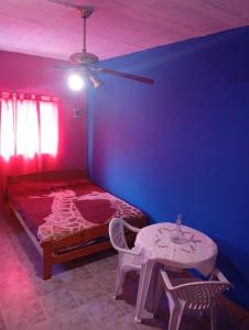 a bedroom with a bed and a table and a ceiling at Albricias in Mina Clavero