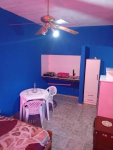 a bedroom with a table and chairs in a room at Albricias in Mina Clavero