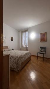 a bedroom with a bed and a chair in it at Alida in Salò