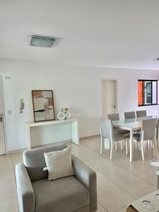 a living room with a couch and a table at Flat espaçoso e confortavel no hotel Canarius Gravata in Gravatá