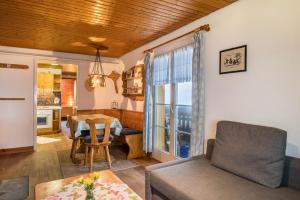 a living room with a couch and a table at Ferienwohnung Landliebe in Wieden