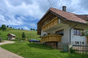 a house with a balcony on the side of it at Ferienwohnung Landliebe in Wieden