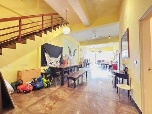 a living room with a dining room table and stairs at 花蓮羽竹民宿 -附車位- in Hualien City