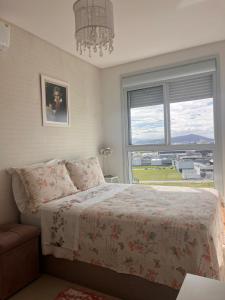 Ένα ή περισσότερα κρεβάτια σε δωμάτιο στο SEU REFÚGIO o seu lar longe de casa