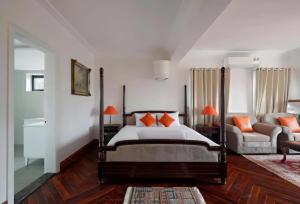 a bedroom with a bed and a couch at Dalat Villaa in Da Lat