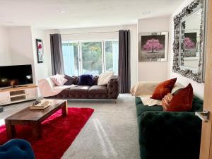 a living room with a couch and a table at Luxury 5 Bedroom House near York - Escrick in Escrick