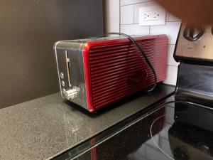a red toaster oven sitting on top of a counter at Creole Nest in New Orleans