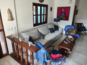 a living room with a couch and a table at Praia litoral norte SP 70 m praia in Caraguatatuba