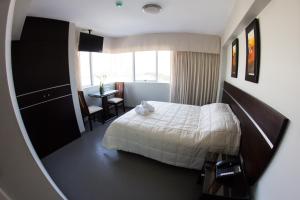 Cama ou camas em um quarto em Mariategui Hotel & Suites