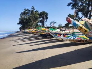 a row of boats lined up on the beach at Baobab Beach Villa in Abene
