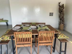 a dining room table with four chairs and a table and chairsuggest at Baobab Beach Villa in Abene