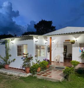 a white house with a patio in front of it at La Casa de Luzma in Pueblo Bello