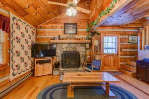 a living room with a fireplace in a log cabin at On The River in Banner Elk
