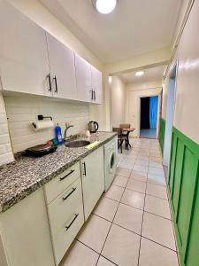 a kitchen with a sink and a dishwasher at Golden Kent APART&SUİTES in Istanbul