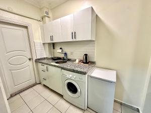 a small kitchen with a washing machine in it at Golden Kent APART&SUİTES in Istanbul +12 photos