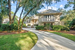 a house with a balcony on a driveway at Cane Current in Hilton Head Island