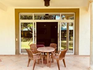 a wooden table and chairs on a patio at Raja Beach Hotel in Balapitiya