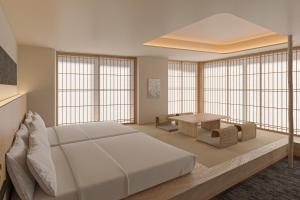 a bedroom with a large bed and a table at Hotel Fork & Knife Miyajima in Miyajima +18 photos