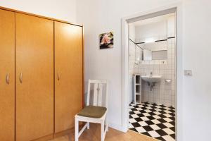 a bathroom with a sink and a chair in a room at Albrechtshof in Neu Fahrland +40 photos