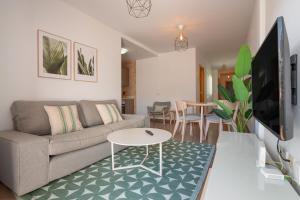 a living room with a couch and a table at Obsidian Aregoma La Caleta in Adeje