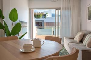 a living room with a table with a coffee cup on it at Obsidian Aregoma La Caleta in Adeje