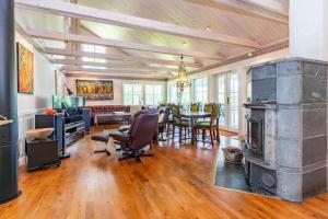 a living room with a fireplace and a dining room at VGO822-Fjaeras-Grimmeredsvaegen-35 in Ubbhult