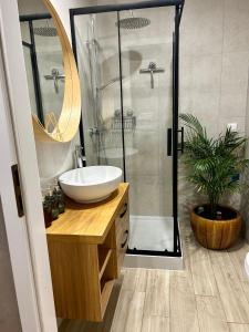 a bathroom with a sink and a shower at Colorado in Gdańsk