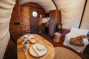 a room with a table and a tent at Sunrise Hills Country in Vălenii de Munte