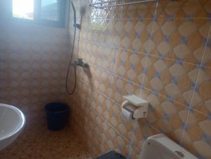 a bathroom with a toilet and a sink at Eastern Comfort Hotel in Koforidua