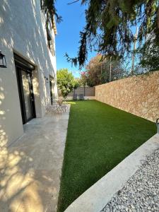 a yard with green grass next to a building at St Paul de Vence in Cagnes-sur-Mer