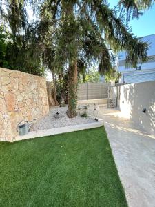 a tree in a yard next to a building at St Paul de Vence in Cagnes-sur-Mer