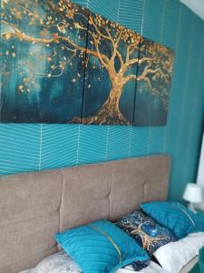 ein Gemälde eines Baumes an der Wand über einem Sofa in der Unterkunft Natura Lux & Parking Free - Green Hill, blizu Akva parka in Sokobanja