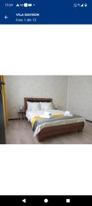 a bed sitting in a room with at Garsoniere in Târgu Jiu