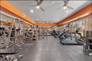a gym with cardio equipment in a building at Cozy, Charming, and Chic Stay in Dallas